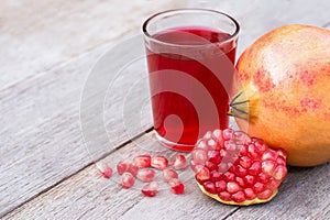 pomegranate fruit and glass of pomegranate juice .