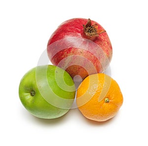 Pomegranade, apple, tangerine on white