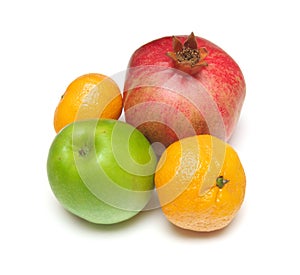 Pomegranade, apple, tangerine on white