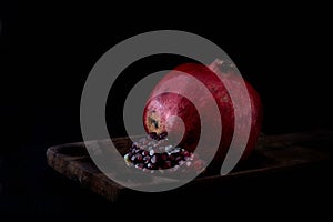 Pomegranade on rustic wood photo