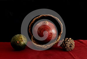 Pomegranate and avocado with pine cone