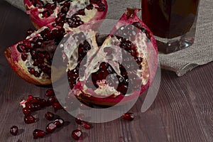 Pomegranate broken and glass of juice