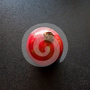 Pomegranate fruit on dark table or kitchen counter