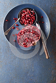 Pomegranate fruit, eating healthy seeds with spoon