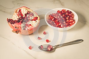 pomegranate fruit, the purified pomegranate seeds in a bowl/pomegranate fruit, the purified pomegranate seeds in a bowl on a white