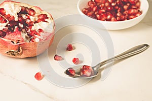 pomegranate fruit, the purified pomegranate seeds in a bowl/pomegranate fruit, the purified pomegranate seeds in a bowl on a white