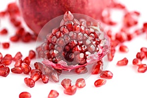 Pomegranate fruit with seeds on white background