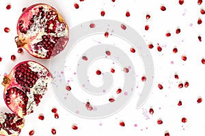 Pomegranate fruit and seeds on white background