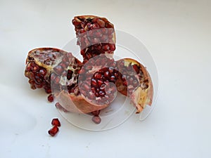 Pomegranate Fruit Sliced into Four Section  on white Background