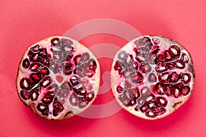 Pomegranate Fruit Two Halves Top Down View on Reg Background