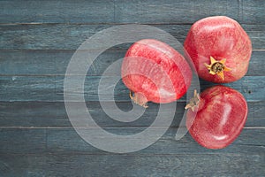 Pomegranate fruits on blue wooden vintage background