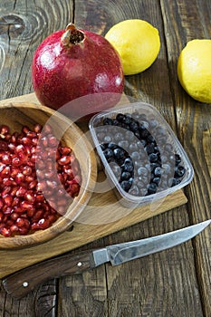 Pomegranate grains in a wooden bowl closeup