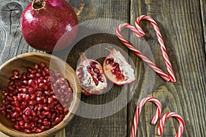 Pomegranate grains in a wooden bowl closeup