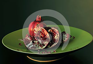 Pomegranate on green dish