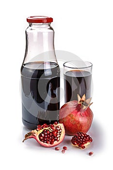 Pomegranate juice in a bottle with glass of juice, fresh pomegranate