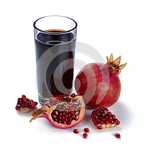 Pomegranate juice in a bottle with glass of juice, fresh pomegranate