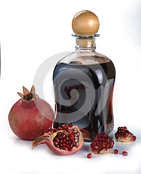 Pomegranate juice in a bottle and pomegranate fruits