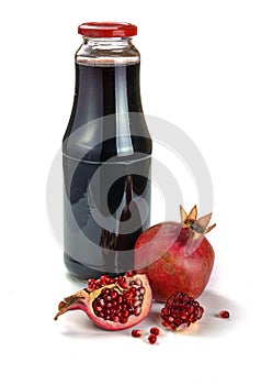 Pomegranate juice in a bottle and pomegranate fruits