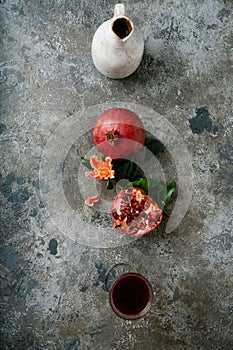 Pomegranate juice and fruits with flowering branches