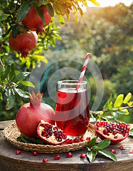 pomegranate juice and fruits on the table in summer garden