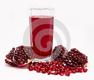 Pomegranate juice in glass and pomegranates  on white