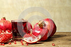 Pomegranate juice with pomegranate fruit on wooden table