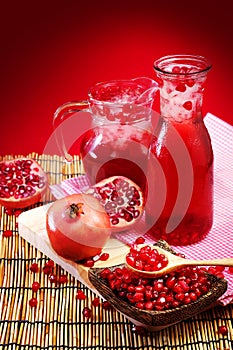 Pomegranate juice with red background photo