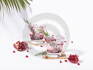 Pomegranate juice with ripe pomegranate on white background. summer drink