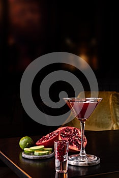 Pomegranate Martini in a night club bar garnished with fruits