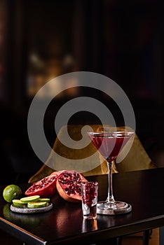 Pomegranate Martini in a night club bar garnished with fruits