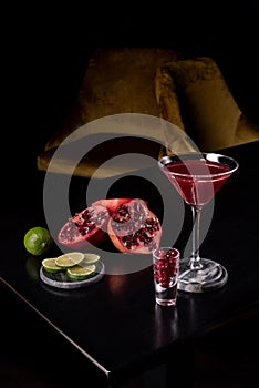 Pomegranate Martini in a night club bar garnished with fruits