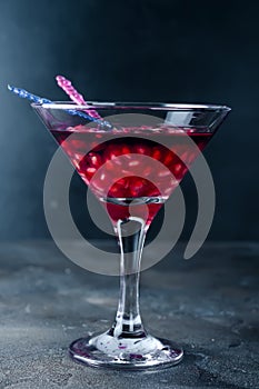 Pomegranate martini with pomegranate seeds in a glass