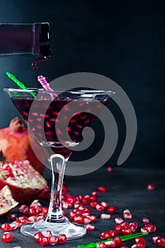 Pomegranate martini with pomegranate seeds in a glass