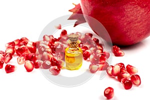 Pomegranate Oil and Seeds Isolated on White Background