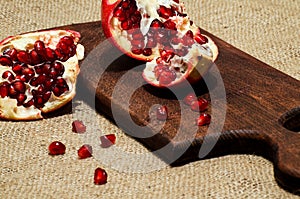 Pomegranate and pomegranate seeds on the kitchen blackboard