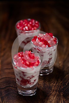 Pomegranate seeds desert two glass isolated background