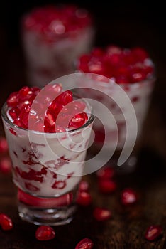 Pomegranate seeds desert two glass isolated background