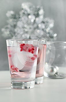 Pomegranate seeds frozen in ice cubes in soda water