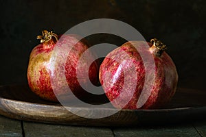 pomegranate seeds fruit Fresh ripe wooden background open dark vintage background still life organic Red vitamins wooden plate