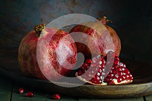 pomegranate seeds fruit Fresh ripe wooden background open dark vintage background still life organic Red vitamins wooden plate