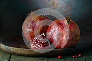 pomegranate seeds fruit Fresh ripe wooden background open dark vintage background still life organic Red vitamins wooden plate