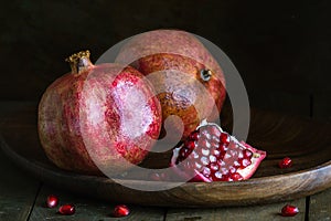 pomegranate seeds fruit Fresh ripe wooden background open dark vintage background still life organic Red vitamins wooden plate