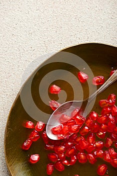 Pomegranate seeds in a metal tray