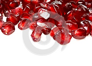 Pomegranate seeds on a white background