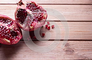 Pomegranate slices and garnet fruit seeds on table