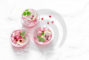 Pomegranate tequila cocktail. Summer light alcoholic drink, cooling aperitif. On light background, top view, free space.