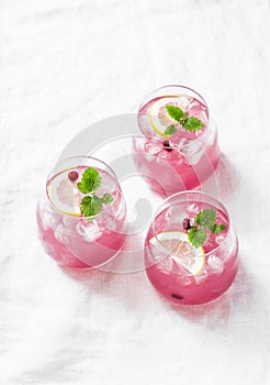 Pomegranate tequila cocktail. Summer light alcoholic drink, cooling aperitif. On light background, top view, free space.