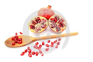 Pomegranate and two cut halves with seeds removed with spoon