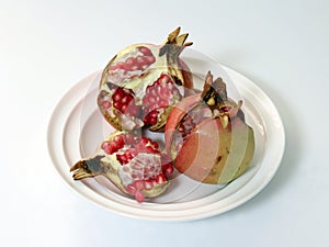 Pomegranate on a white plate.