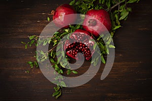 pomegranates with leaves, on a wooden table, rustic style